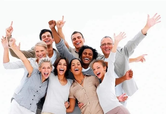 Nine adults from different ethnicities getting close together for a candid, happy group pose